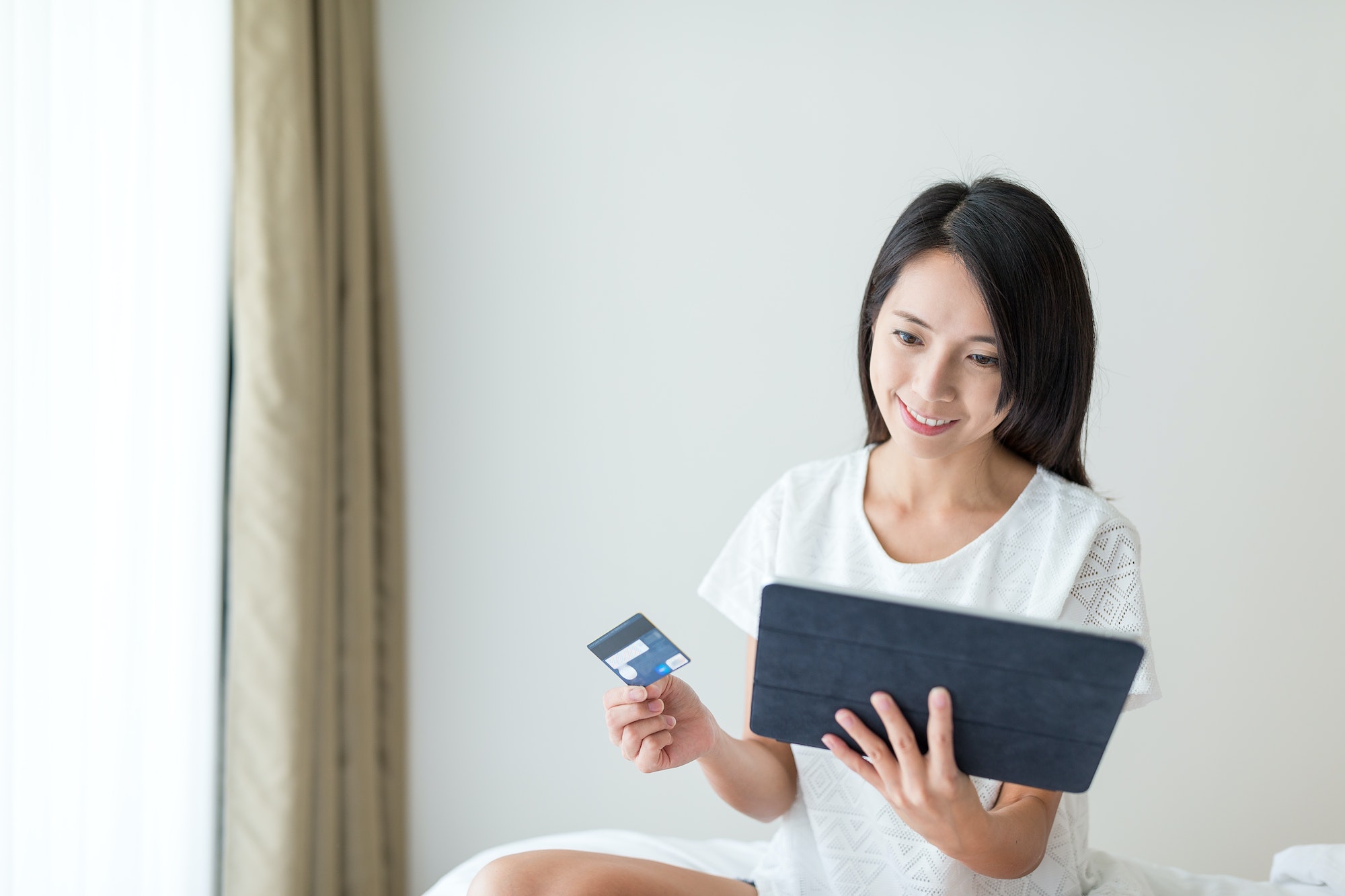 Woman shopping online with tablet and credit card